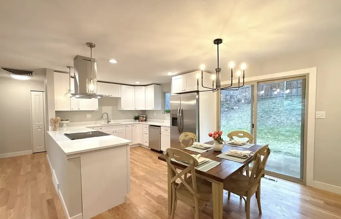 Remodeled open kitchen with white cabinets, quartz island and new appliances, Arvada 80004