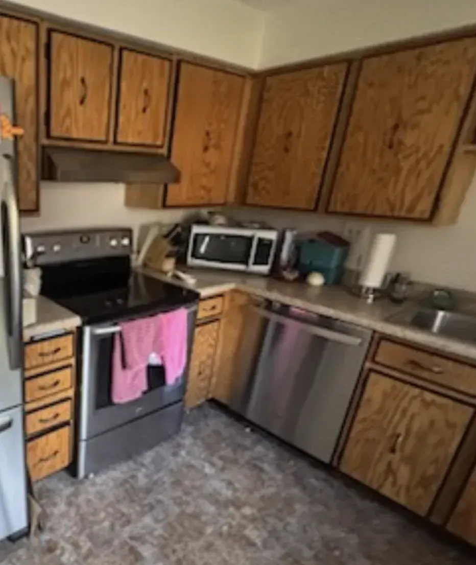 Dated kitchen with original oak cabinets and worn vinyl flooring before renovation, Arvada 80004