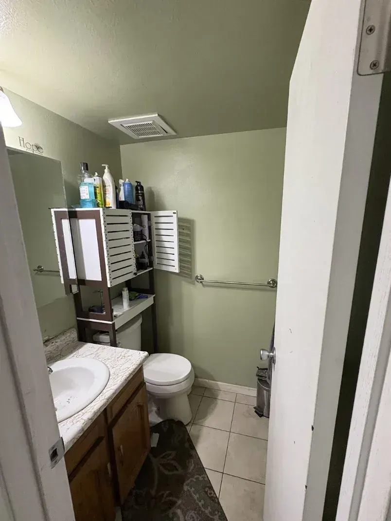 Bathroom of an Aurora, Colorado house bought as-is by Windcrest Investments, before