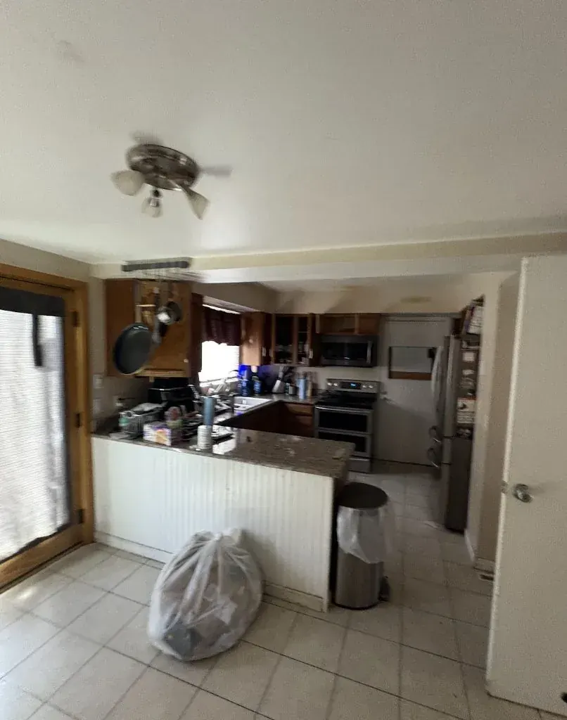 Kitchen of an Aurora, Colorado house bought as-is by Windcrest Investments, before
