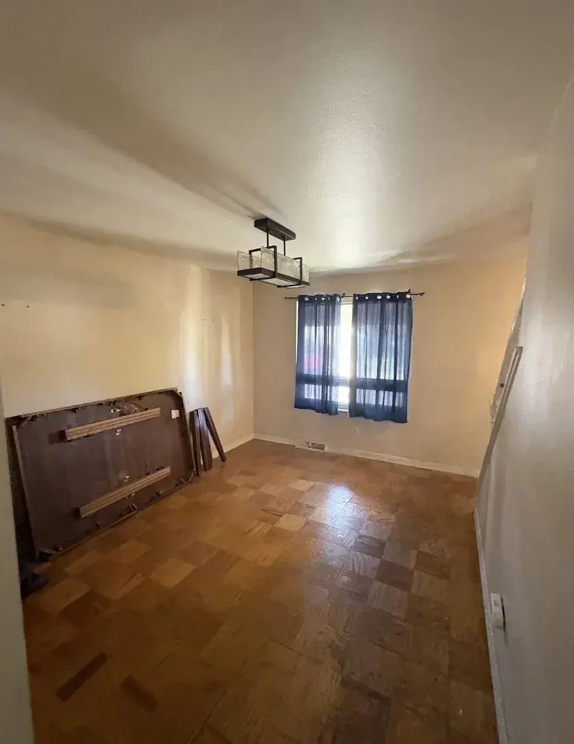 Living Room of an Aurora, Colorado house bought as-is by Windcrest Investments, before