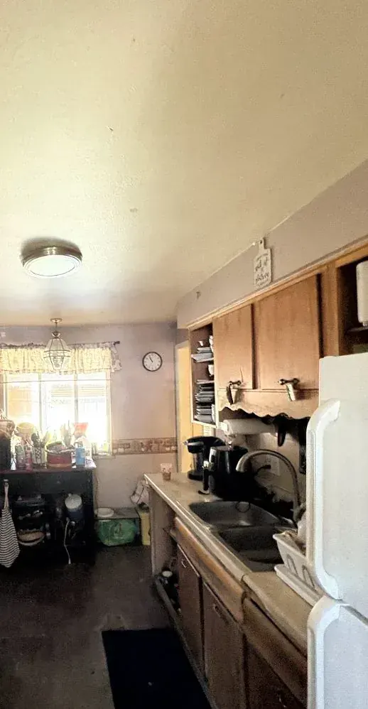Kitchen of a Lakewood, Colorado house bought as-is by Windcrest Investments, before